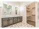 Modern bathroom featuring dual sinks, elegant fixtures, and a large closet at 10101 E Posada Ave, Mesa, AZ 85212