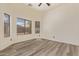 Neutral toned bedroom features luxury vinyl flooring and bright natural light at 10101 E Posada Ave, Mesa, AZ 85212