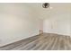 Spacious bedroom featuring light gray wood flooring, white walls, and ample natural light at 10101 E Posada Ave, Mesa, AZ 85212