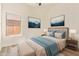 This bedroom features a neutral color palette, a comfortable queen bed, and light wood-look flooring at 10101 E Posada Ave, Mesa, AZ 85212