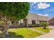 Modern home showcasing a lush lawn, desert plants, and a minimalist design with a light-colored exterior at 10101 E Posada Ave, Mesa, AZ 85212