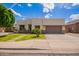 Contemporary home with a well-maintained front yard, desert landscaping, and a spacious two-car garage at 10101 E Posada Ave, Mesa, AZ 85212