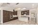 Modern kitchen with stainless steel appliances, granite counters, and a large island with a crystal chandelier at 10101 E Posada Ave, Mesa, AZ 85212