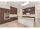 Modern kitchen showcasing dark wood cabinets, white subway tile backsplash, granite countertops, and a center island at 10101 E Posada Ave, Mesa, AZ 85212
