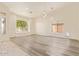 Open-concept living space with modern flooring, paneling, recessed lighting, and large windows at 10101 E Posada Ave, Mesa, AZ 85212