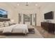 Staged main bedroom with hardwood floors, large windows, and neutral decor for a serene and inviting space at 10101 E Posada Ave, Mesa, AZ 85212