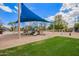 Community playground with slides, swings, and climbing structures surrounded by green space at 10101 E Posada Ave, Mesa, AZ 85212