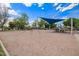 A community playground with swings, slides, and sunshade provides hours of enjoyment at 10101 E Posada Ave, Mesa, AZ 85212