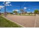 Community sand volleyball court with lush landscaping providing a fun recreational amenity for residents at 10101 E Posada Ave, Mesa, AZ 85212