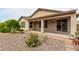 Charming backyard with desert landscaping, patio, and desert-friendly plants at 12121 W Patrick Ln, Sun City, AZ 85373