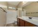 Well-lit bathroom with a tub and shower combination, vanity, and large mirror at 12121 W Patrick Ln, Sun City, AZ 85373