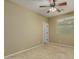 Bedroom with soft carpeting and a ceiling fan, complemented by a window and door at 12121 W Patrick Ln, Sun City, AZ 85373