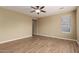 Bright bedroom with wood-look floors and a large window, providing ample natural light at 12121 W Patrick Ln, Sun City, AZ 85373