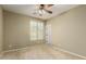 Carpeted bedroom featuring a bright window and a ceiling fan for added comfort at 12121 W Patrick Ln, Sun City, AZ 85373