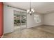 Dining area with sliding glass doors leading to the backyard, perfect for indoor-outdoor entertaining at 12121 W Patrick Ln, Sun City, AZ 85373