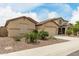 Desirable property featuring low-maintenance front yard landscaping, two-car garage, and tasteful exteriors at 12121 W Patrick Ln, Sun City, AZ 85373
