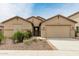 Inviting single-story home featuring a neutral-toned exterior, well-manicured landscaping, and a two-car garage at 12121 W Patrick Ln, Sun City, AZ 85373