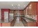 Updated kitchen with stainless steel appliances, granite countertops, and stylish backsplash at 12121 W Patrick Ln, Sun City, AZ 85373