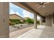Covered patio overlooking desert landscaping and mature trees at 12121 W Patrick Ln, Sun City, AZ 85373