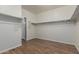 Walk-in closet featuring wood-look flooring and built in shelving ready for organizing your wardrobe at 12121 W Patrick Ln, Sun City, AZ 85373