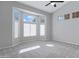 Bright bedroom featuring a large bay window that fills the room with natural light, accentuating the soft carpet at 1325 W Muirwood Dr, Phoenix, AZ 85045