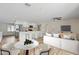 Bright, open-concept living space with a modern kitchen, bar seating, and contemporary furnishings at 2161 E Gemini Dr, Tempe, AZ 85283