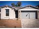 Charming single-story home featuring a stone-accented facade and a well-maintained, neutral-toned exterior at 5414 W Las Palmaritas Dr, Glendale, AZ 85302