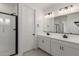 Modern bathroom featuring dual sinks, quartz countertop and tiled shower at 5419 W Las Palmaritas Dr, Glendale, AZ 85302
