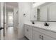 Bright bathroom featuring a double vanity, sleek countertops, and modern fixtures in a neutral color palette at 5419 W Las Palmaritas Dr, Glendale, AZ 85302