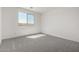 Bright bedroom features plush gray carpet and a large window at 5419 W Las Palmaritas Dr, Glendale, AZ 85302