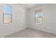 Neutral bedroom with tile floors, two windows, and ample natural light at 5419 W Las Palmaritas Dr, Glendale, AZ 85302