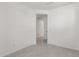Clean and neutral bedroom with tile floors and an open doorway at 5419 W Las Palmaritas Dr, Glendale, AZ 85302