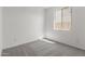 Minimalist bedroom featuring neutral carpet, paint, and a sunny window at 5419 W Las Palmaritas Dr, Glendale, AZ 85302