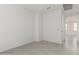Bedroom featuring wood-look tile, neutral paint, and a hallway view at 5419 W Las Palmaritas Dr, Glendale, AZ 85302