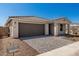 Captivating curb appeal with a modern home, a two-car garage, paved driveway, and desert-friendly landscaping at 5419 W Las Palmaritas Dr, Glendale, AZ 85302