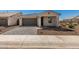 Welcoming home exterior featuring a modern garage, a paved driveway, and well-maintained front yard landscaping at 5419 W Las Palmaritas Dr, Glendale, AZ 85302