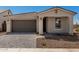 Charming single-story home featuring a gray garage door and meticulously designed paver driveway at 5419 W Las Palmaritas Dr, Glendale, AZ 85302