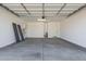 Spacious two-car garage with concrete flooring, white walls, and an automatic door at 5419 W Las Palmaritas Dr, Glendale, AZ 85302