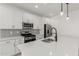 Bright kitchen boasts white cabinetry, stainless steel appliances, and a modern island with a sleek faucet at 5419 W Las Palmaritas Dr, Glendale, AZ 85302