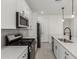 Well-lit kitchen showcasing white cabinets, stainless steel appliances, and modern fixtures and finishes at 5419 W Las Palmaritas Dr, Glendale, AZ 85302