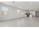 Spacious, open-concept living area that flows into the kitchen with white cabinetry and modern finishes at 5419 W Las Palmaritas Dr, Glendale, AZ 85302