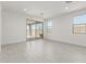 Spacious living area featuring stylish tile flooring and access to an outdoor covered patio at 5419 W Las Palmaritas Dr, Glendale, AZ 85302