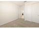 Bedroom with double door closet and view of kitchen at 9115 N 173Rd Ln, Waddell, AZ 85355