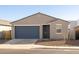 Newly constructed home with a two-car garage and desert landscaping at 9115 N 173Rd Ln, Waddell, AZ 85355