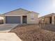 New construction home with a two-car garage and rock landscaping at 9115 N 173Rd Ln, Waddell, AZ 85355