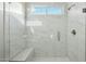 Modern bathroom featuring a glass shower with marble tile and a built-in bench at 13634 S 192Nd Ave, Buckeye, AZ 85326