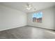 Bright bedroom with hardwood floors, a ceiling fan, and a scenic outdoor view at 13634 S 192Nd Ave, Buckeye, AZ 85326