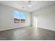 Bright bedroom with hardwood floors, a ceiling fan, and a scenic outdoor view at 13634 S 192Nd Ave, Buckeye, AZ 85326