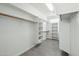 Spacious walk-in closet with custom shelving and wood-look floors providing ample storage at 13634 S 192Nd Ave, Buckeye, AZ 85326
