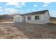 Well-lit single-story home with desert landscaping, a covered patio and a two-car garage at 13634 S 192Nd Ave, Buckeye, AZ 85326